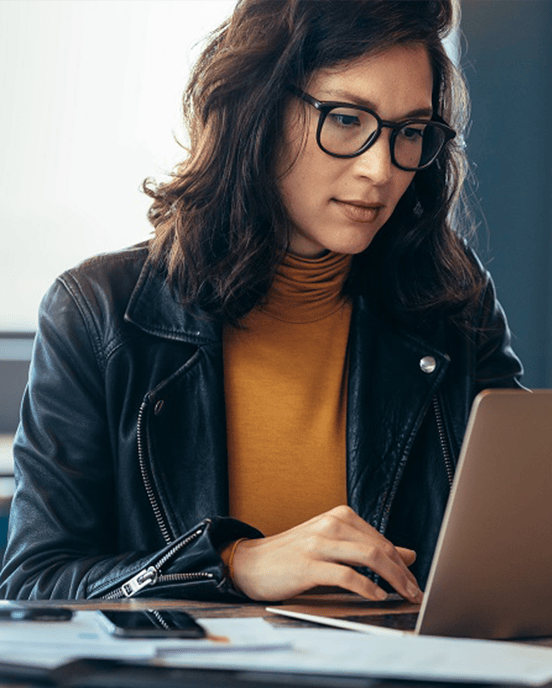 Woman sitting at desk working on laptop