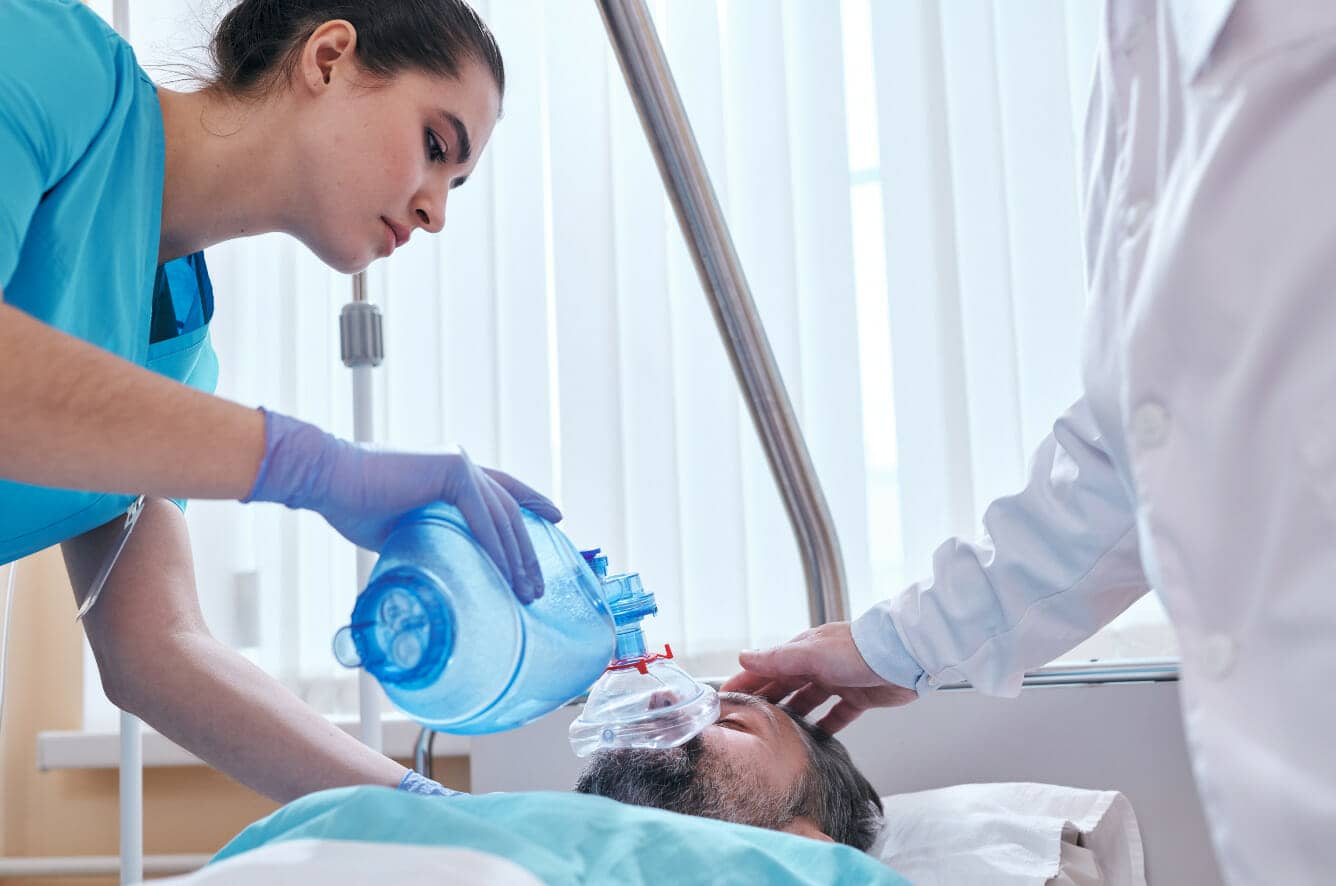 Respiratory Therapist gives inhaler to young boy