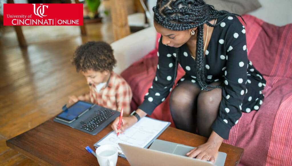 Photo of African American mom and young son studying together