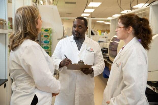 Laboratory scientists taking direction from their director in the laboratory 